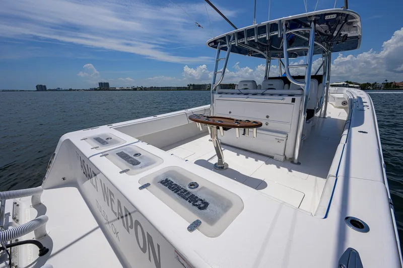 Slide: The Image of 2023 Contender 44 ST boat on water, featuring spacious deck and seating. - 41