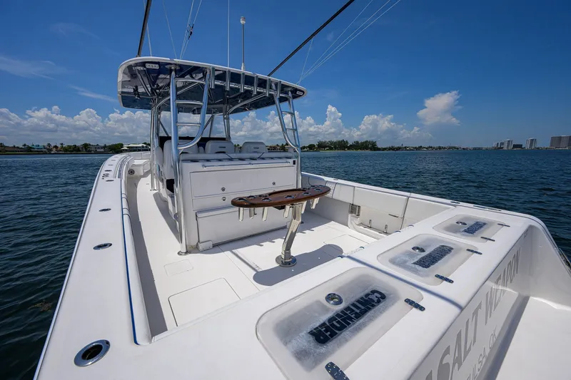 Slide: The Image of 2023 Contender 44 ST boat on calm water, showcasing spacious deck and seating. - 44