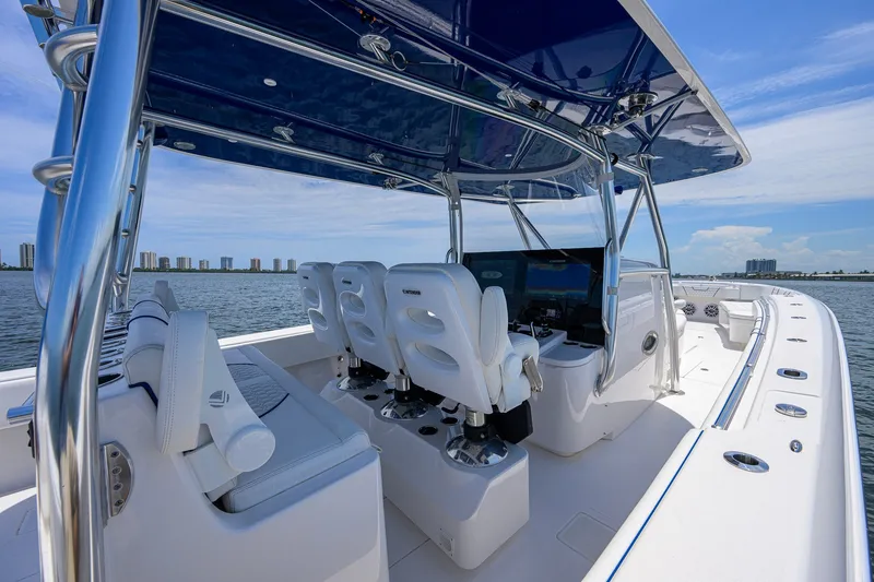 Slide: The Image of 2023 Contender 44 ST boat interior with sleek seating and modern controls on open water. - 32