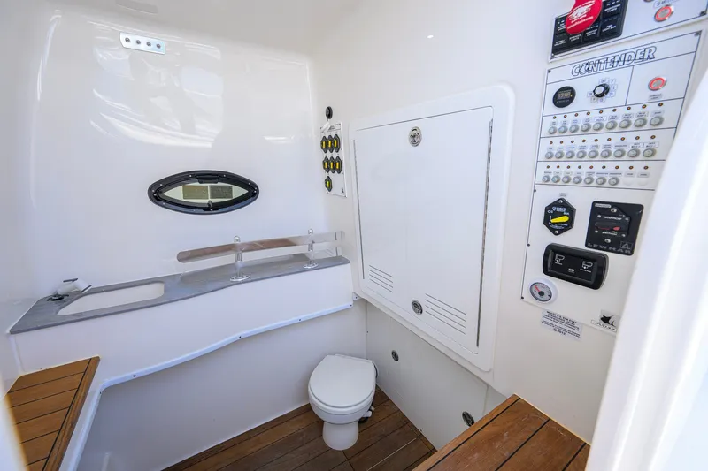 Slide: The Image of 2023 Contender 44 ST boat interior with control panel, sink, and toilet. - 64