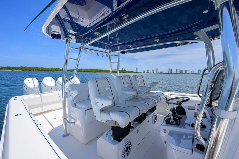 Slide: The Image of 2023 Contender 44 ST boat interior with luxurious seating and modern controls on open water. - 34