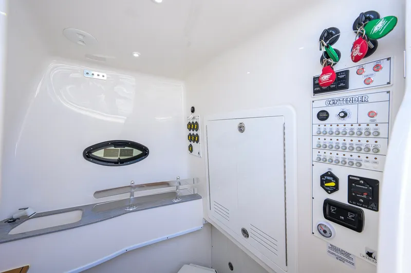 Slide: The Image of Interior view of 2023 Contender 44 ST boat control panel and storage area. - 63