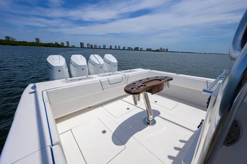 Slide: The Image of 2023 Contender 44 ST boat with four Mercury engines on a calm water backdrop. - 40