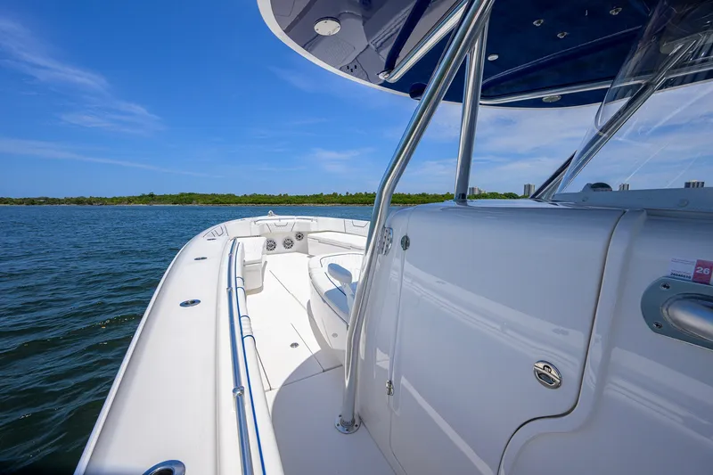 Slide: The Image of 2023 Contender 44 ST boat on open water under clear blue sky. - 16