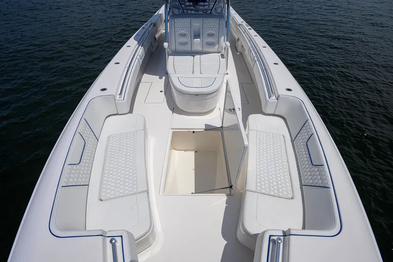 Slide: The Image of 2023 Contender 44 ST boat interior with cushioned seating and open storage compartment. - 23