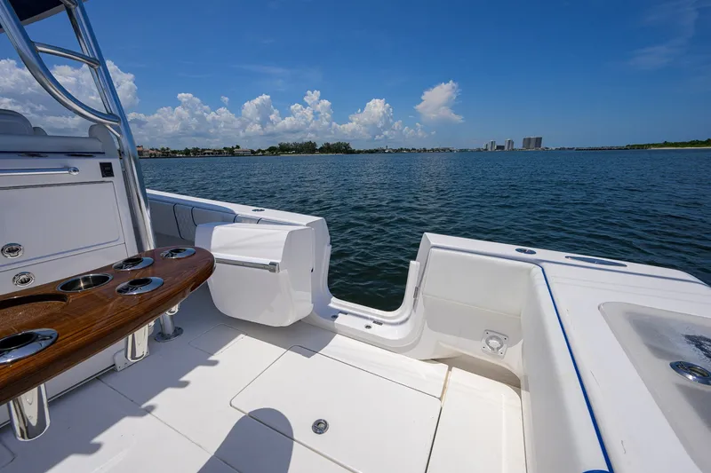 Slide: The Image of 2023 Contender 44 ST boat interior with ocean view, featuring sleek seating and cup holders. - 49