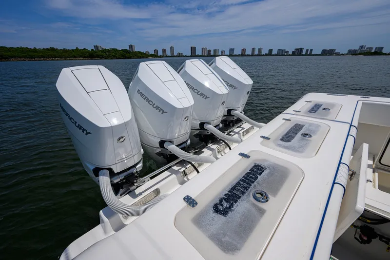 Slide: The Image of 2023 Contender 44 ST boat with triple Mercury outboard engines on a calm waterway. - 53