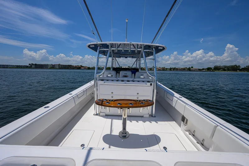 Slide: The Image of 2023 Contender 44 ST boat on water, clear sky, spacious deck view. - 43