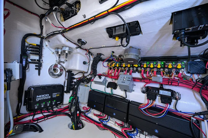 Slide: The Image of Electrical system inside a 2023 Contender 44 ST boat, featuring wiring and components. - 69