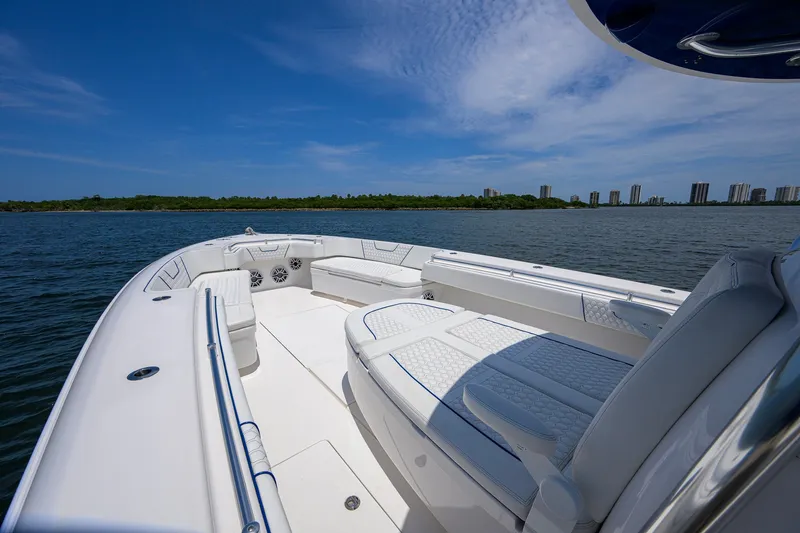 Slide: The Image of 2023 Contender 44 ST boat on water, featuring spacious seating and sleek design. - 17