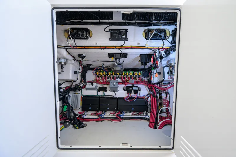 Slide: The Image of Electrical panel of 2023 Contender 44 ST boat, showcasing organized wiring and components. - 66