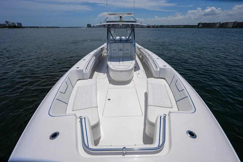Slide: The Image of 2023 Contender 44 ST boat on water, featuring spacious seating and sleek design. - 24