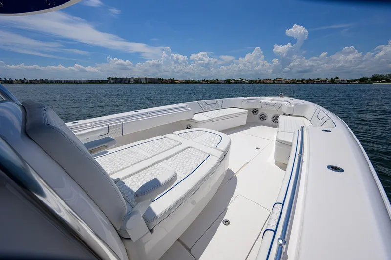 Slide: The Image of 2023 Contender 44 ST boat with spacious seating on calm waters under a blue sky. - 28