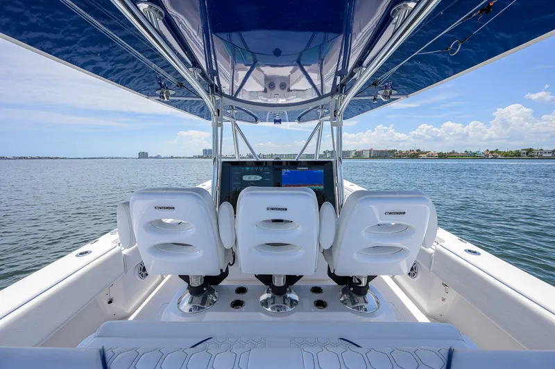 Slide: The Image of 2023 Contender 44 ST boat interior with three white seats and ocean view. - 12
