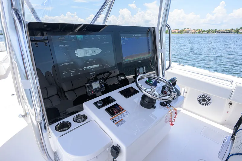Slide: The Image of 2023 Contender 44 ST boat dashboard with advanced navigation system and steering wheel. - 14