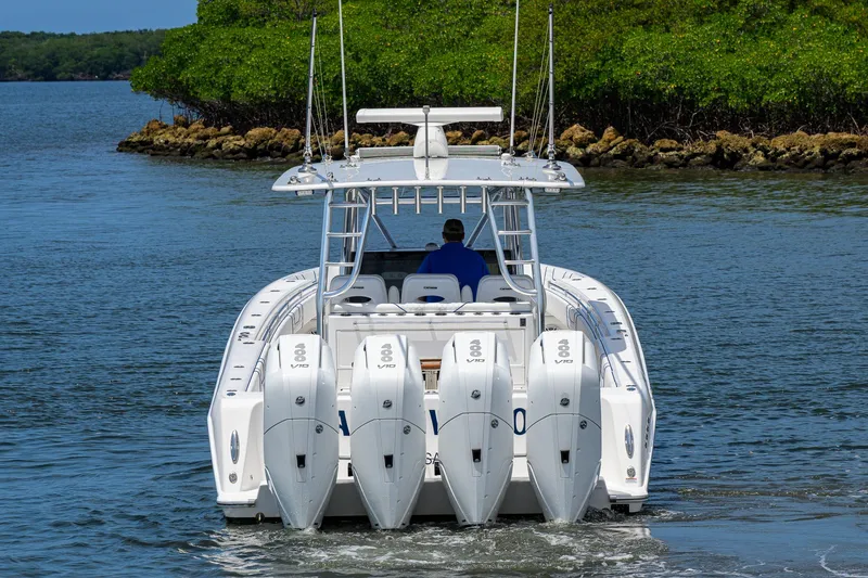 Slide: The Image of 2023 Contender 44 ST boat with four powerful engines cruising on water. - 7