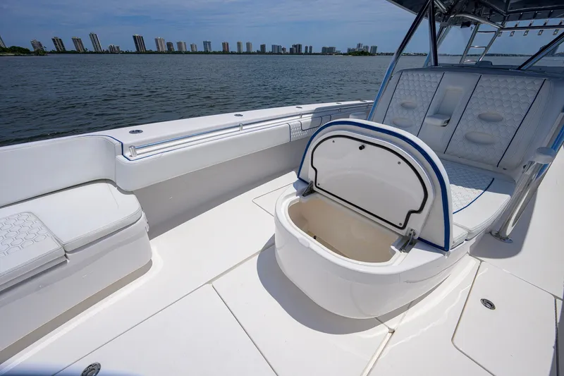 Slide: The Image of 2023 Contender 44 ST boat interior with open storage compartment, overlooking city skyline. - 25