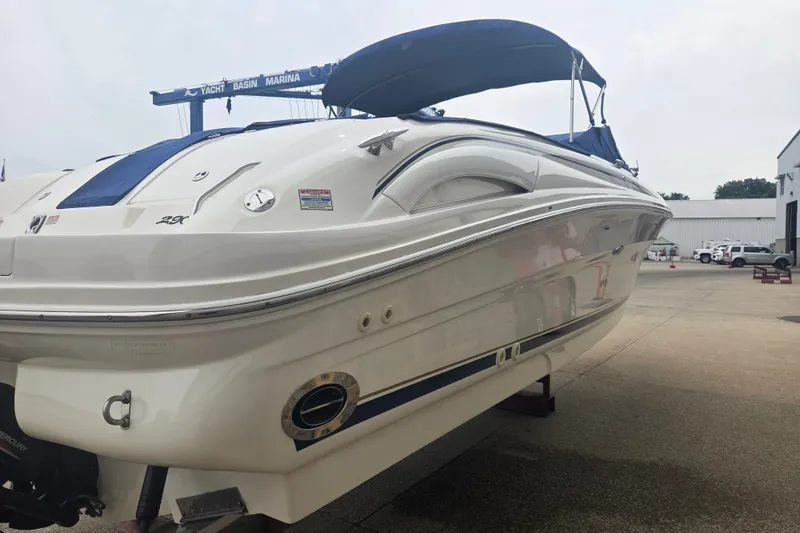 Slide: The Image of 2001 Sea Ray 290 Bow Rider boat with blue canopy at marina. - 3