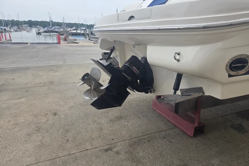 Slide: The Image of Rear view of a 2001 Sea Ray 290 Bow Rider boat on a dock. - 4
