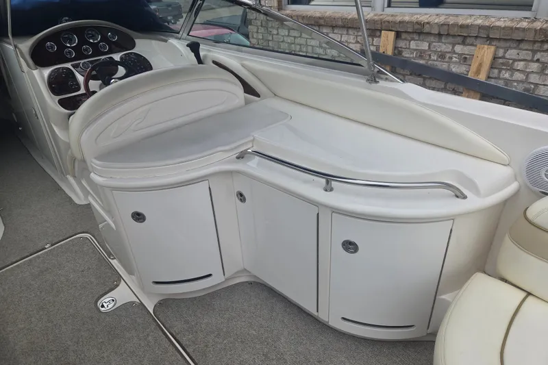 Slide: The Image of 2001 Sea Ray 290 Bow Rider interior with helm and seating area. - 16