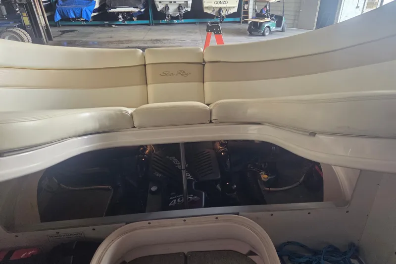 Slide: The Image of 2001 Sea Ray 290 Bow Rider interior with engine compartment open, showcasing seating and engine details. - 19