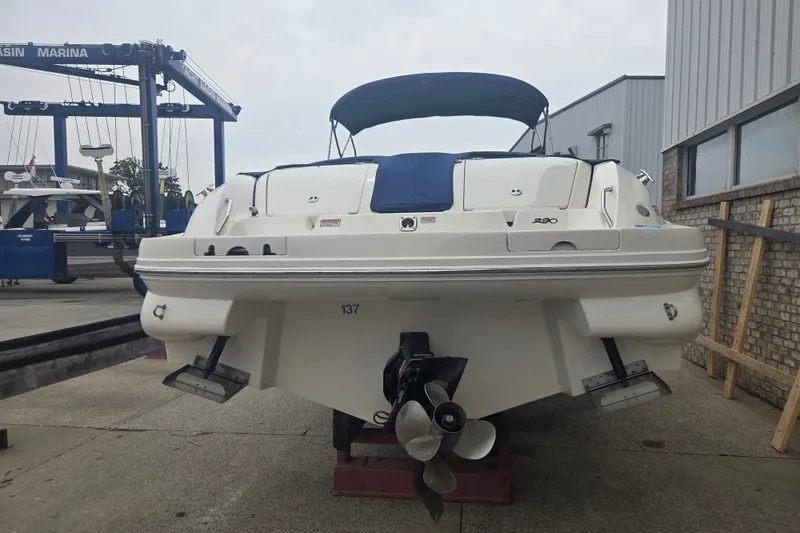 Slide: The Image of 2001 Sea Ray 290 Bow Rider boat at marina, rear view with propeller and canopy. - 6