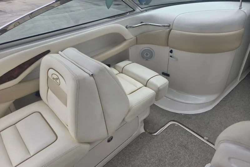 Slide: The Image of Interior of 2001 Sea Ray 290 Bow Rider with beige leather seating and carpeted floor. - 13