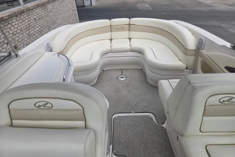 Slide: The Image of 2001 Sea Ray 290 Bow Rider interior with white leather seating and carpeted floor. - 9