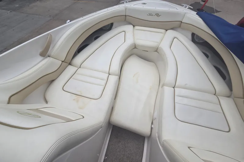 Slide: The Image of 2001 Sea Ray 290 Bow Rider boat interior with white cushioned seating. - 14