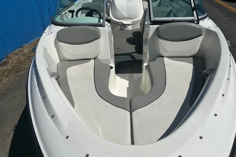 Slide: The Image of 2011 Bayliner 175 Bowrider boat interior with gray and white seating. - 5