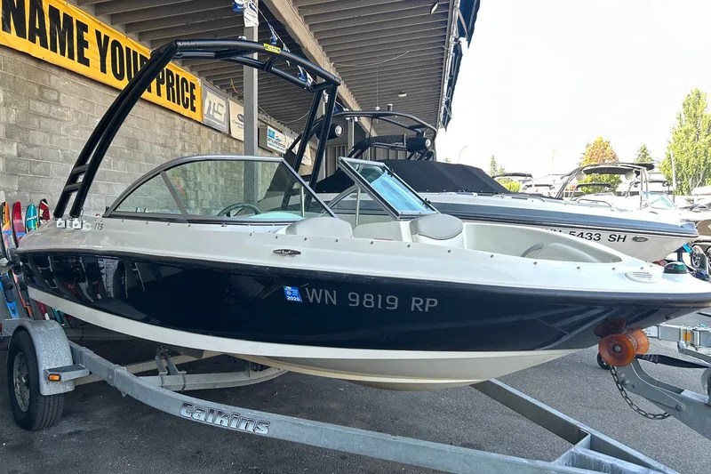 Slide: The Image of 2011 Bayliner 175 Bowrider boat on trailer in showroom, side view. - 1