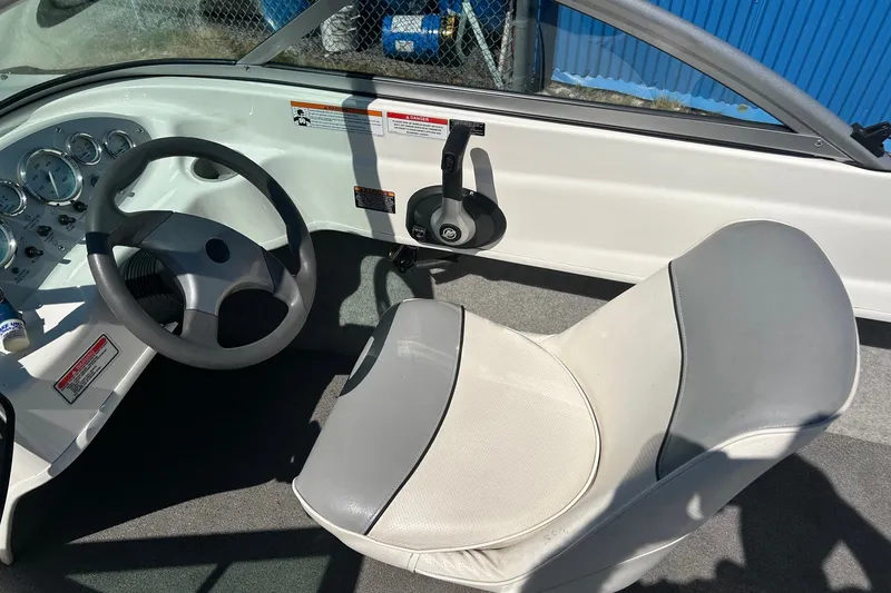 Slide: The Image of 2011 Bayliner 175 Bowrider cockpit with steering wheel and seat, showcasing dashboard controls. - 4