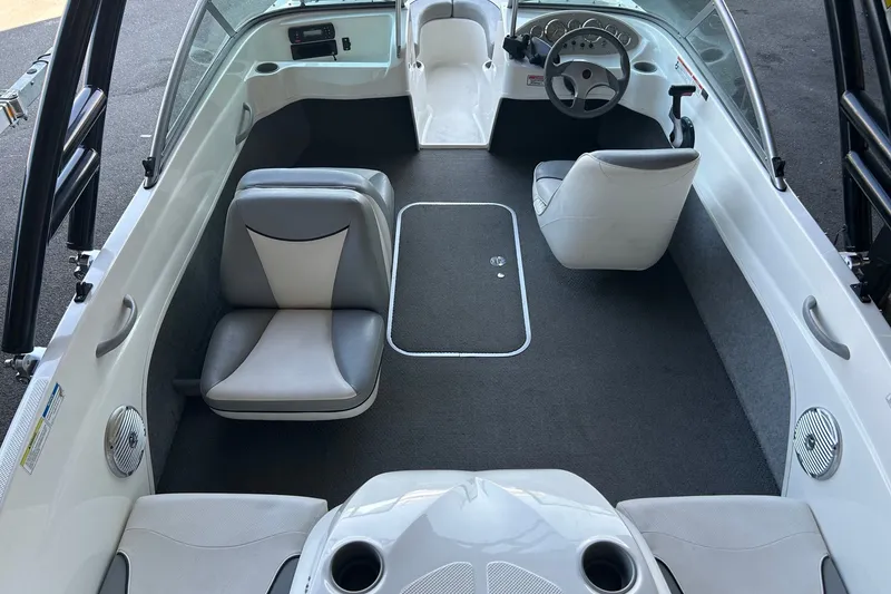 Slide: The Image of 2011 Bayliner 175 Bowrider interior with gray seating and steering console. - 10