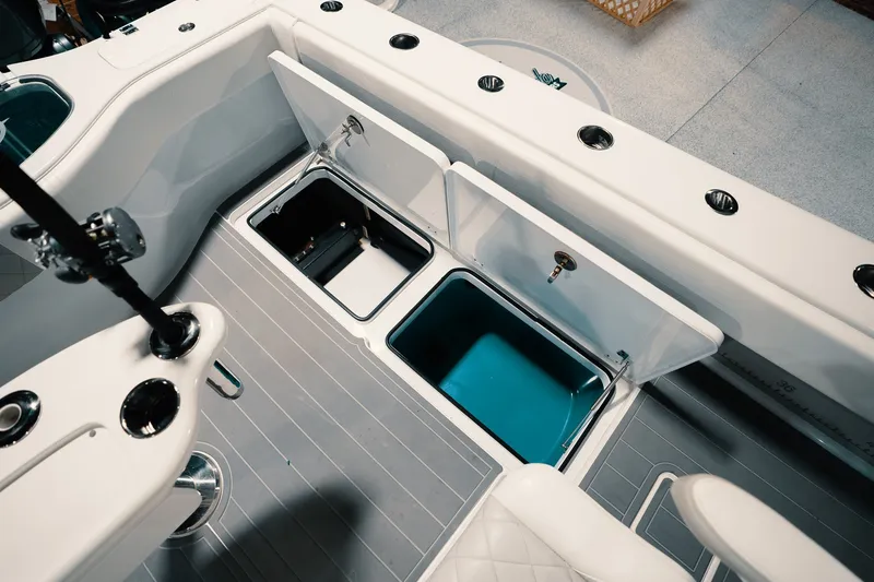 Slide: The Image of 2023 Freeman 42LR boat interior with open storage compartments and fishing rod holders. - 48