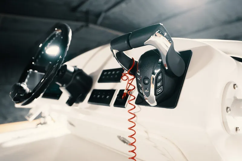 Slide: The Image of Control panel of 2023 Freeman 42LR boat with steering wheel and throttle. - 64