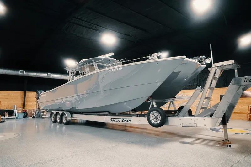 Slide: The Image of 2023 Freeman 42LR boat on trailer in indoor showroom setting. - 32