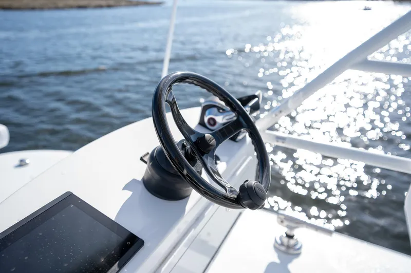 Slide: The Image of Steering wheel of 2023 Freeman 42LR boat with water in the background. - 19