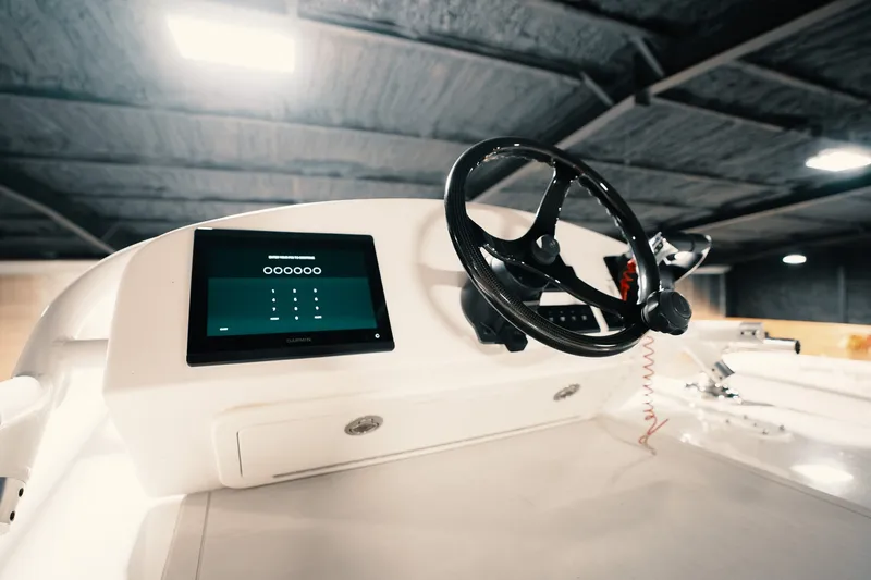 Slide: The Image of 2023 Freeman 42LR boat dashboard with steering wheel and digital display. - 62