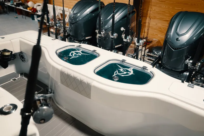 Slide: The Image of 2023 Freeman 42LR boat interior with fishing rods and engines in view. - 42