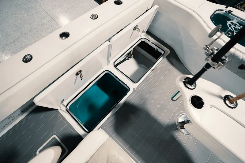 Slide: The Image of 2023 Freeman 42LR boat interior with open storage compartments and fishing rod holders. - 49
