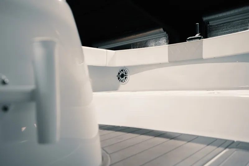 Slide: The Image of Interior view of 2023 Freeman 42LR boat, showcasing sleek white design and speaker detail. - 89