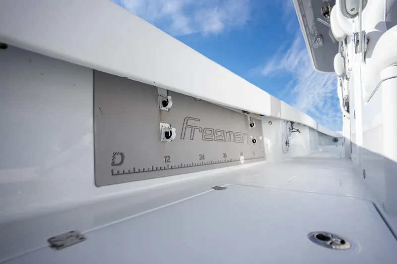 Slide: The Image of Freeman 42LR 2023 boat interior with branded panel and clear blue sky. - 16