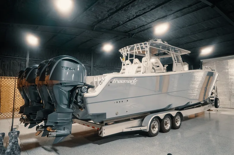 Slide: The Image of 2023 Freeman 42LR boat with Yamaha engines on a trailer in a garage. - 39