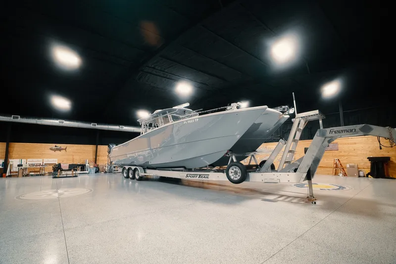 Slide: The Image of 2023 Freeman 42LR boat on trailer in spacious indoor facility. - 34