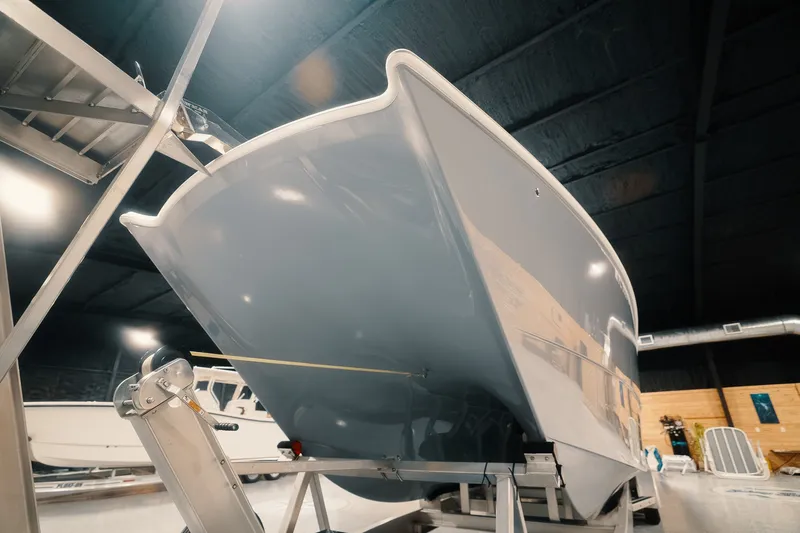 Slide: The Image of 2023 Freeman 42LR boat displayed indoors, showcasing sleek hull design. - 30