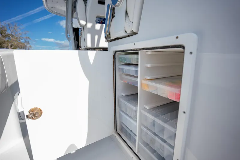 Slide: The Image of Freeman 42LR 2023 boat storage compartment with organized tackle boxes. - 15