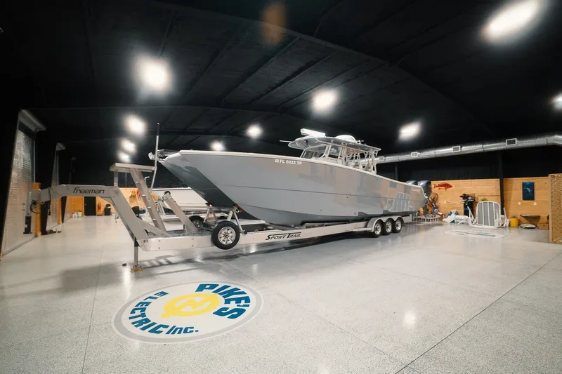 Slide: The Image of 2023 Freeman 42LR boat on trailer in spacious indoor facility. - 22