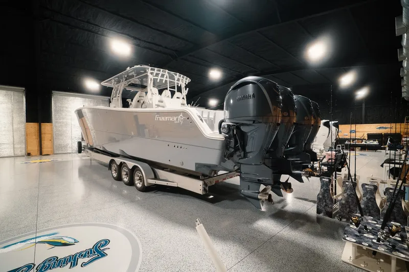 Slide: The Image of 2023 Freeman 42LR boat with Yamaha engines in a showroom setting. - 26