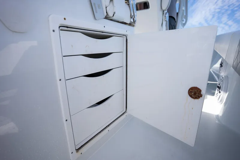 Slide: The Image of Open storage compartment with drawers on a 2023 Freeman 42LR boat. - 14