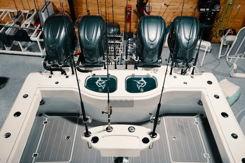 Slide: The Image of 2023 Freeman 42LR boat with four powerful engines and fishing rods in a sleek setup. - 59